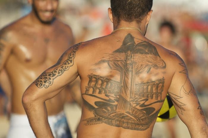 Mountains near Rio de Janeiro tattooed on a man's upper back.