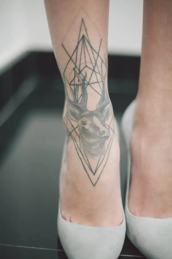 Closeup of a deer tattoo on a woman's ankle.