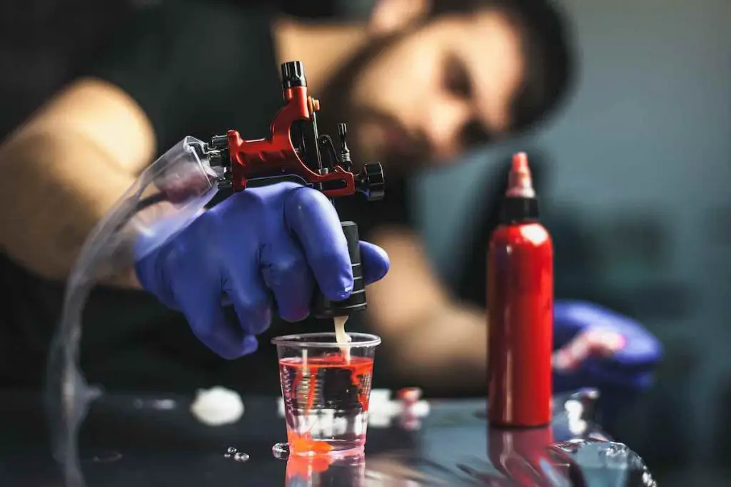 A tattooist using a tattoo gun.