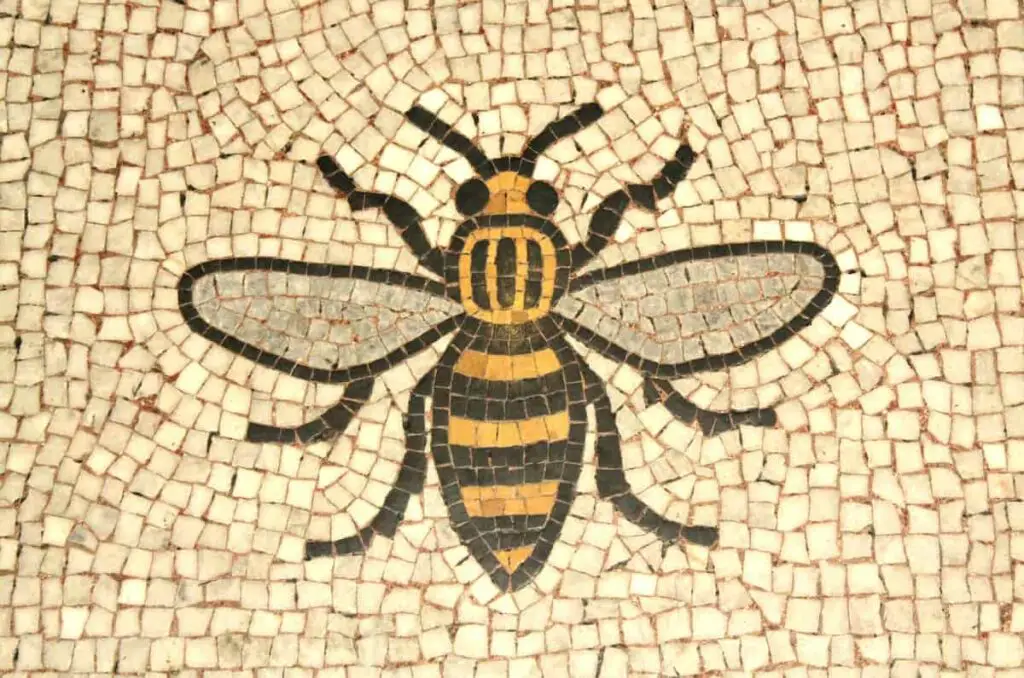 A bee mosaic design. Some bee tattoo meanings are based on their significance in cultures and art.