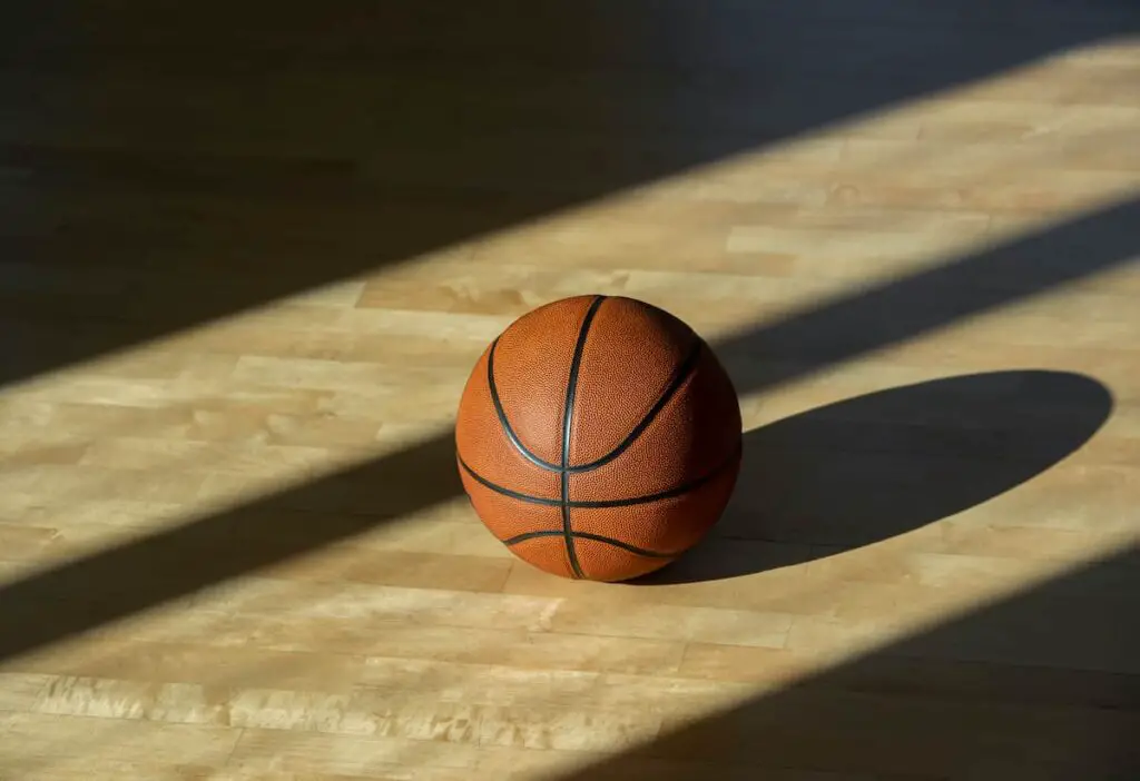 A basketball on the floor of a court.