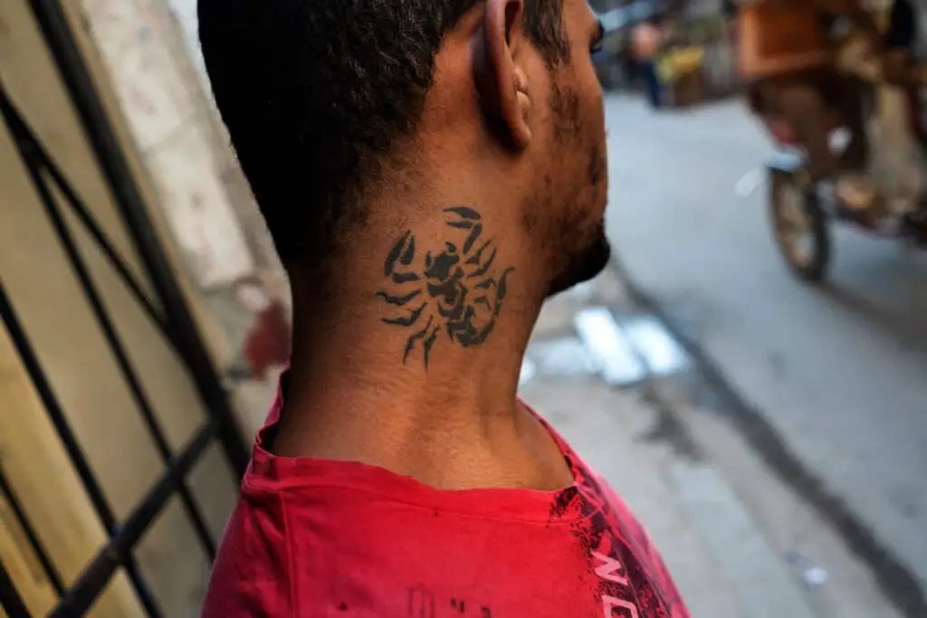 A scorpion tattoo on a man's neck. Scorpion tattoo meaning.