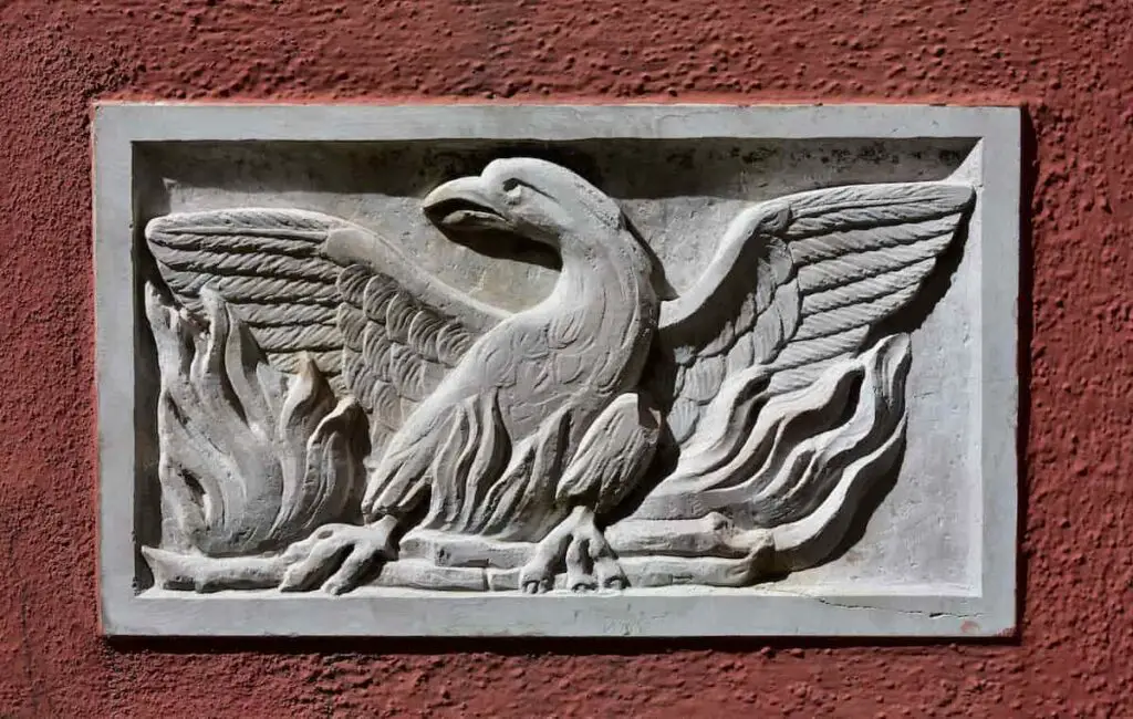 A wall carving of a phoenix rising from flames.