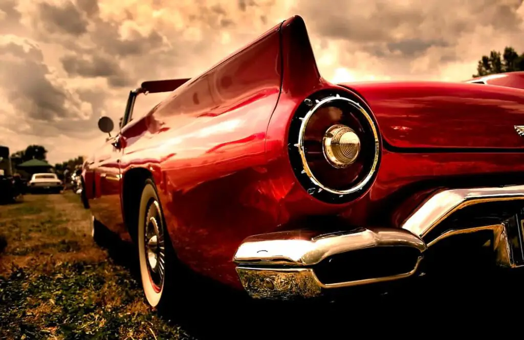 Closeup angled view of a red classic car.