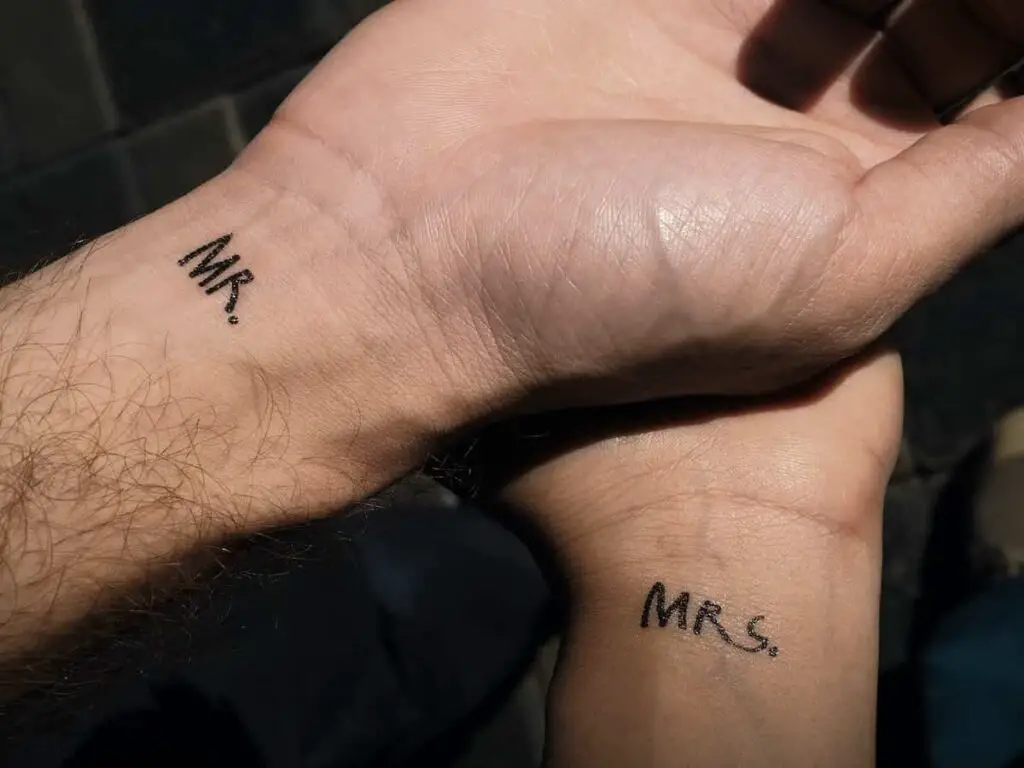 A tattoo design for couples with Mr. on his wrist and Mrs. on her wrist.