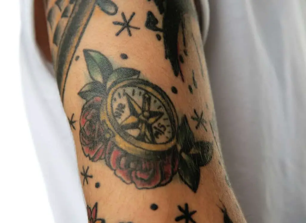 A compass tattoo in old school tattoo style. Compass tattoo meaning.