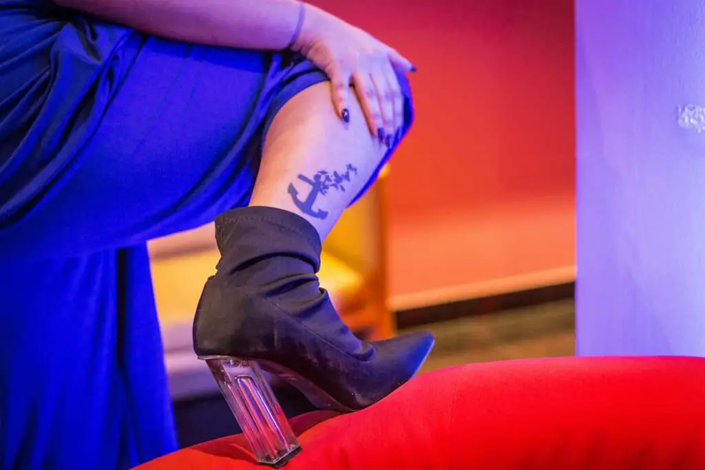 A woman with an anchor tattoo near her ankle. Anchor tattoo meaning.