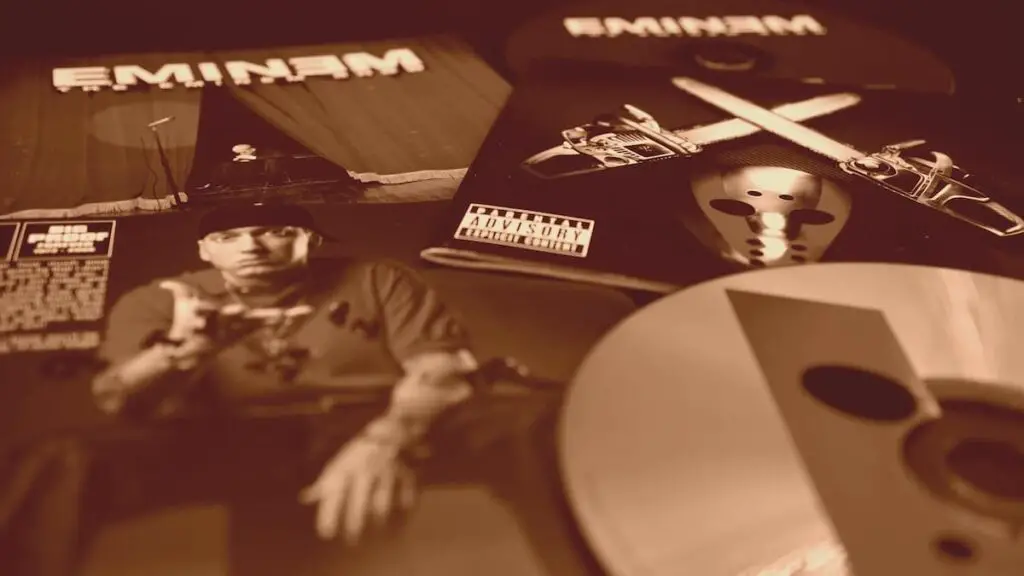 A sepia-toned photo of various Eminem albums and CDs.
