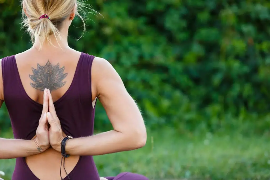 A lotus flower tattoo on a woman's back.