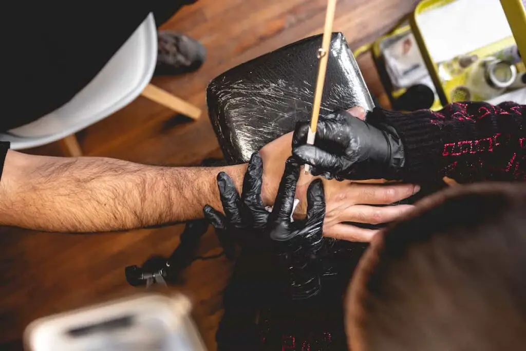 Traditional hand poke tattoo method.
