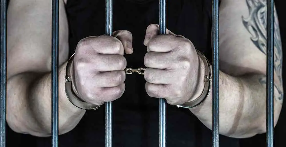 person handcuffed in prison