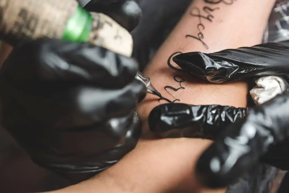 tattoo artist giving someone a tattoo
