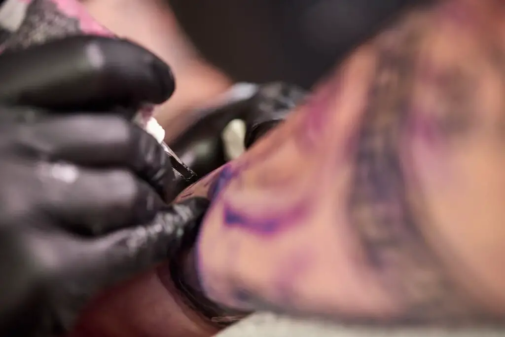 Closeup of tattoo artist working.