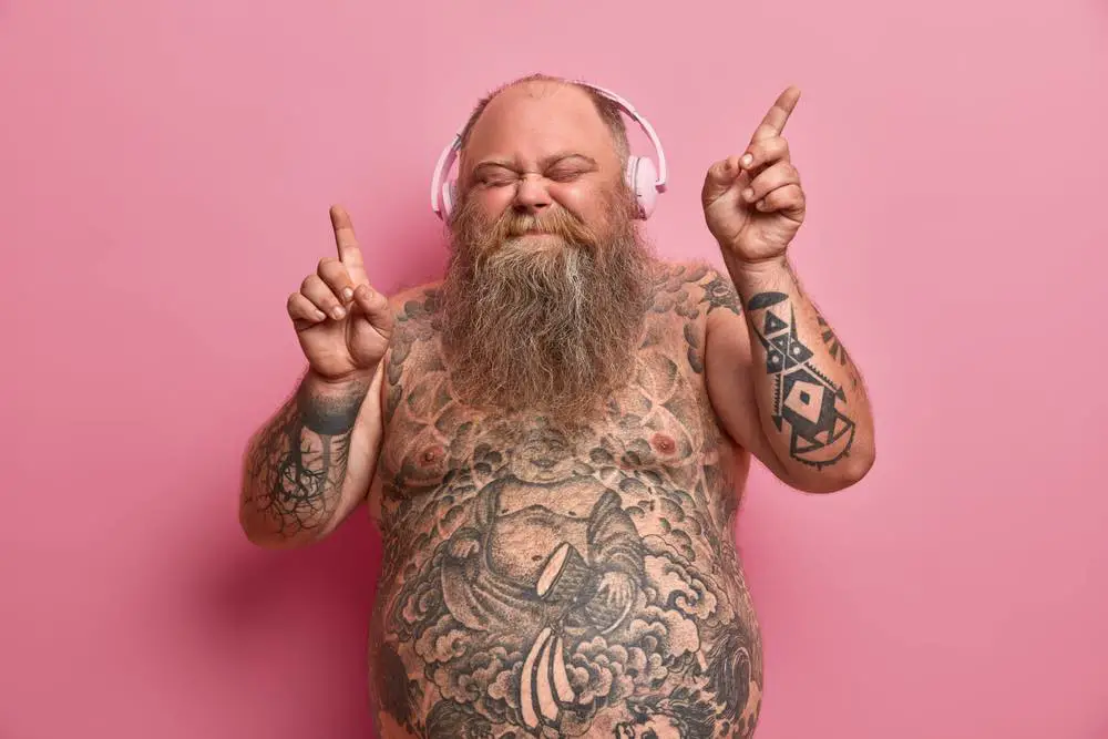 tattooed man enjoying his music