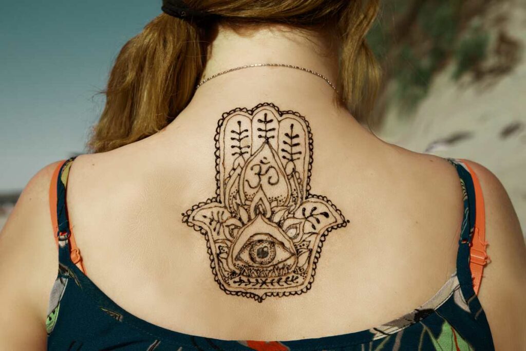 Hamsa hand chest under boob tattoo by Wes Fortier - Burnin… | Flickr